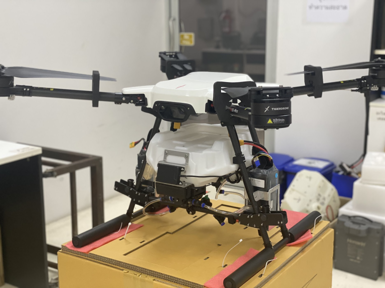 University drone lab with supervised battery charging, modular packs, and smart BMS monitoring on a tablet