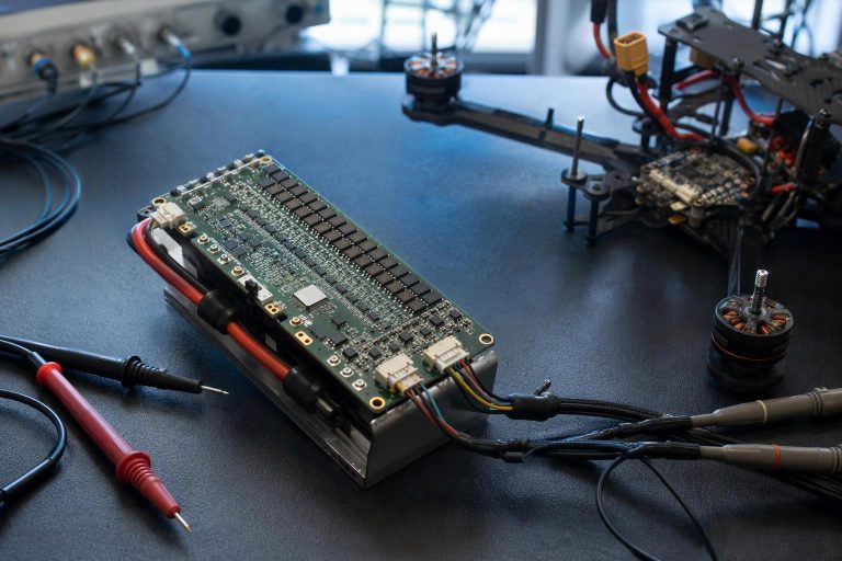 Diagram of a drone battery management system connecting over CAN, SMBus and UART to a flight controller and charger